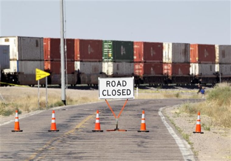 The frontage road along Interstate 8 is closed Thursday, May 12, 2011, in Gila Bend, Ariz., hours after a train and Border Patrol vehicle collided in the early morning hours. (AP Photo/Matt York)